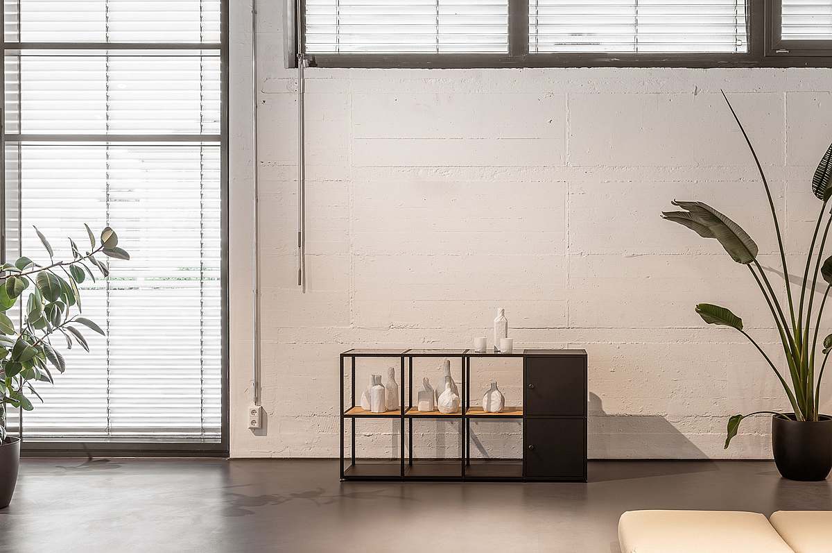 A slim nomo sideboard with open storage spaces on both sides organizes the living space.